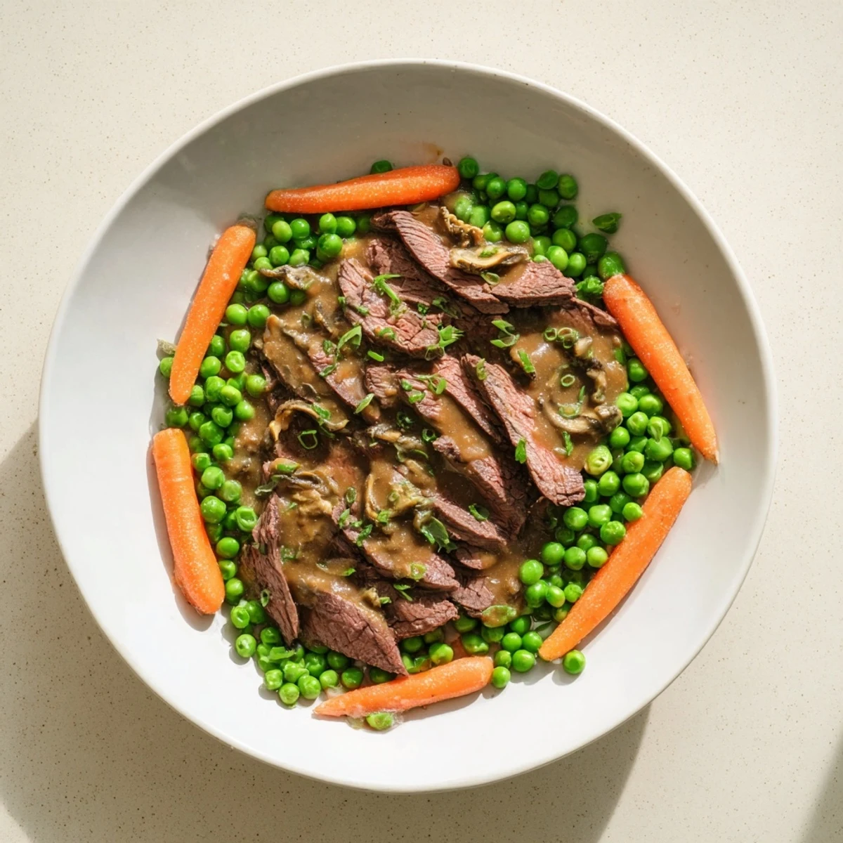 Skillet Beef Stir-Fry with bright snap peas and carrots glistening from a savory sauce and ready to eat.