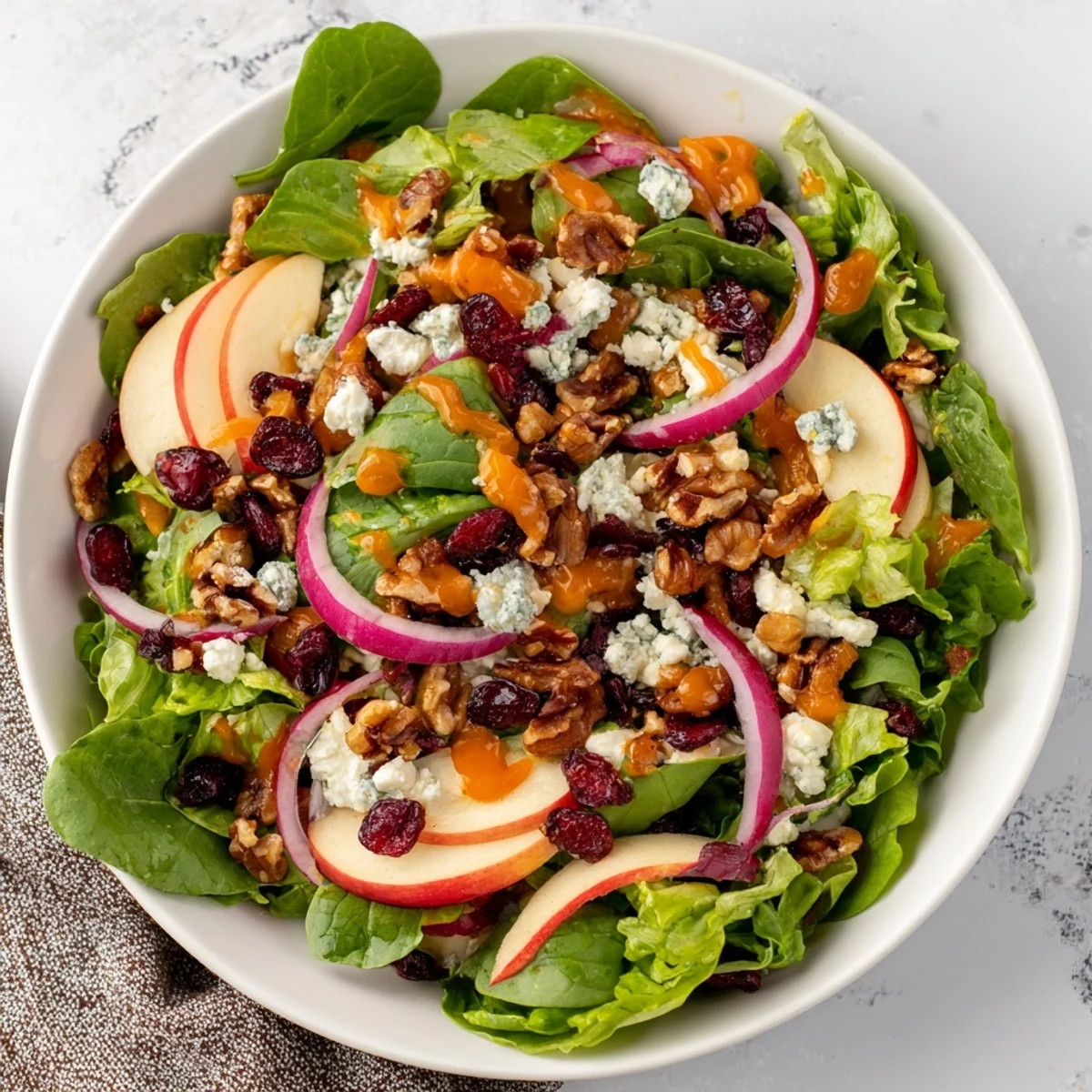 Bright photo of the Seasonal Cranberry and Walnut Celebration Salad, ready to enjoy with a tangy orange vinaigrette.