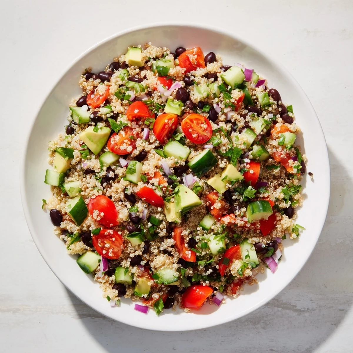 Fresh, colorful quinoa and black bean salad, with avocado and a zesty lime dressing.
