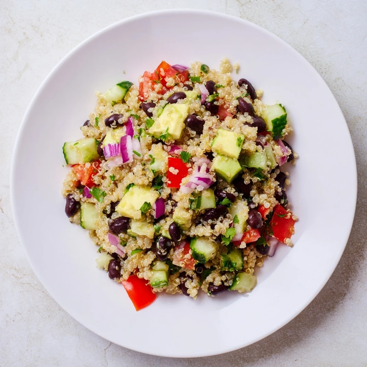 A bowl of refreshing quinoa and black bean salad with vibrant vegetables, perfect for lunch.