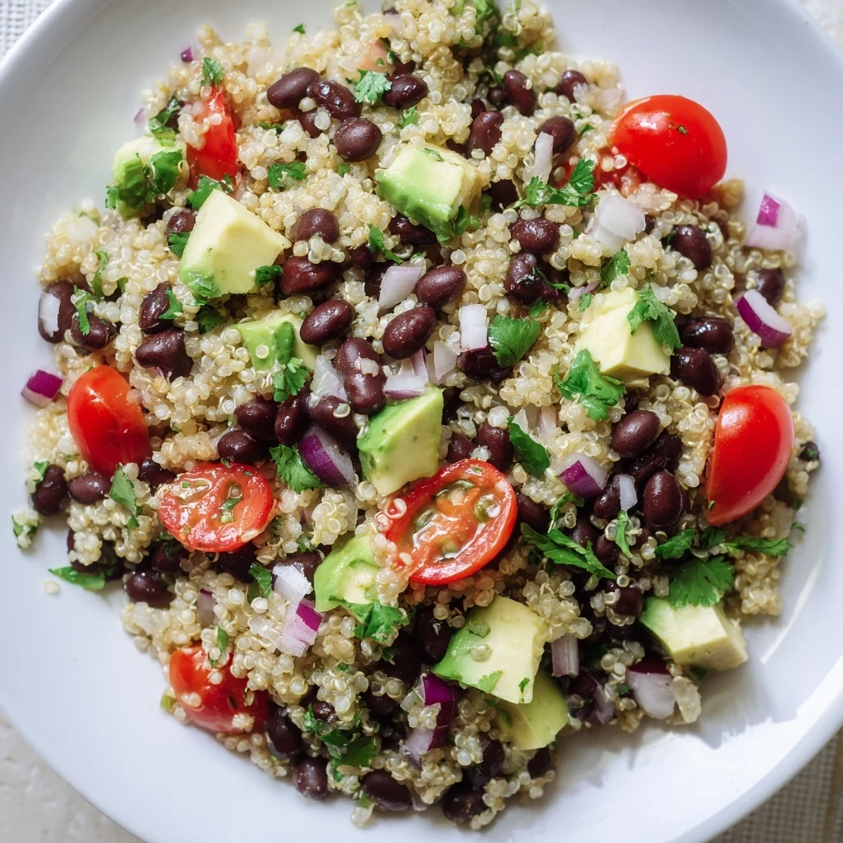 A refreshing bowl of Quinoa Black Bean Salad featuring avocado, ready to serve and enjoy.