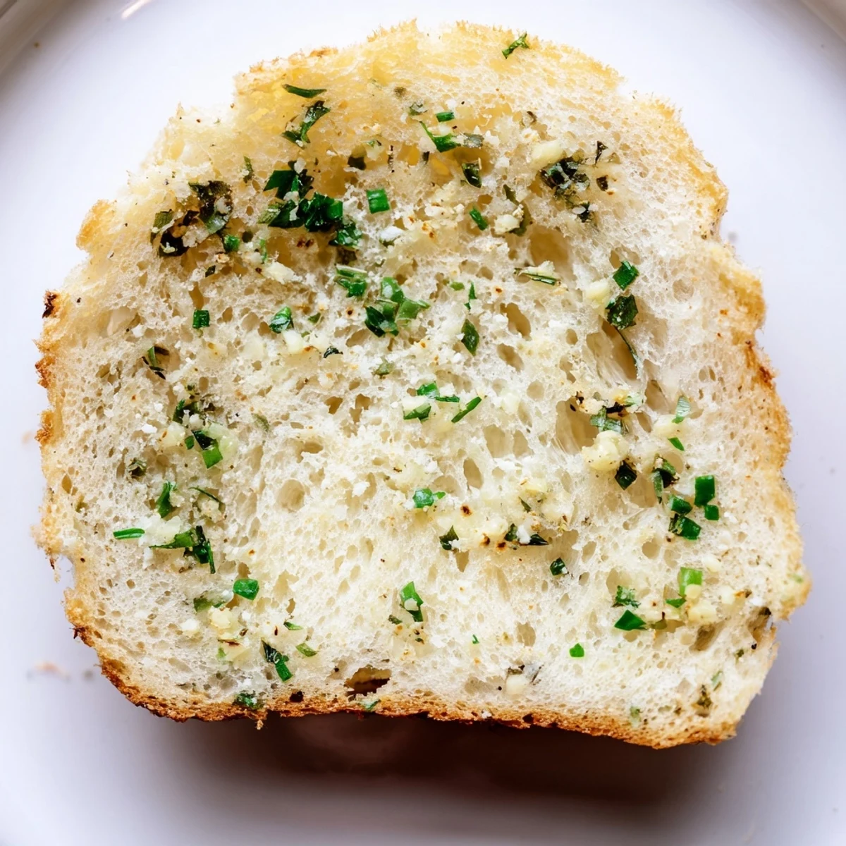A close-up view of airy, gluten-free cloud bread savory toasts, showcasing the fluffy texture and melted Parmesan within each bite.