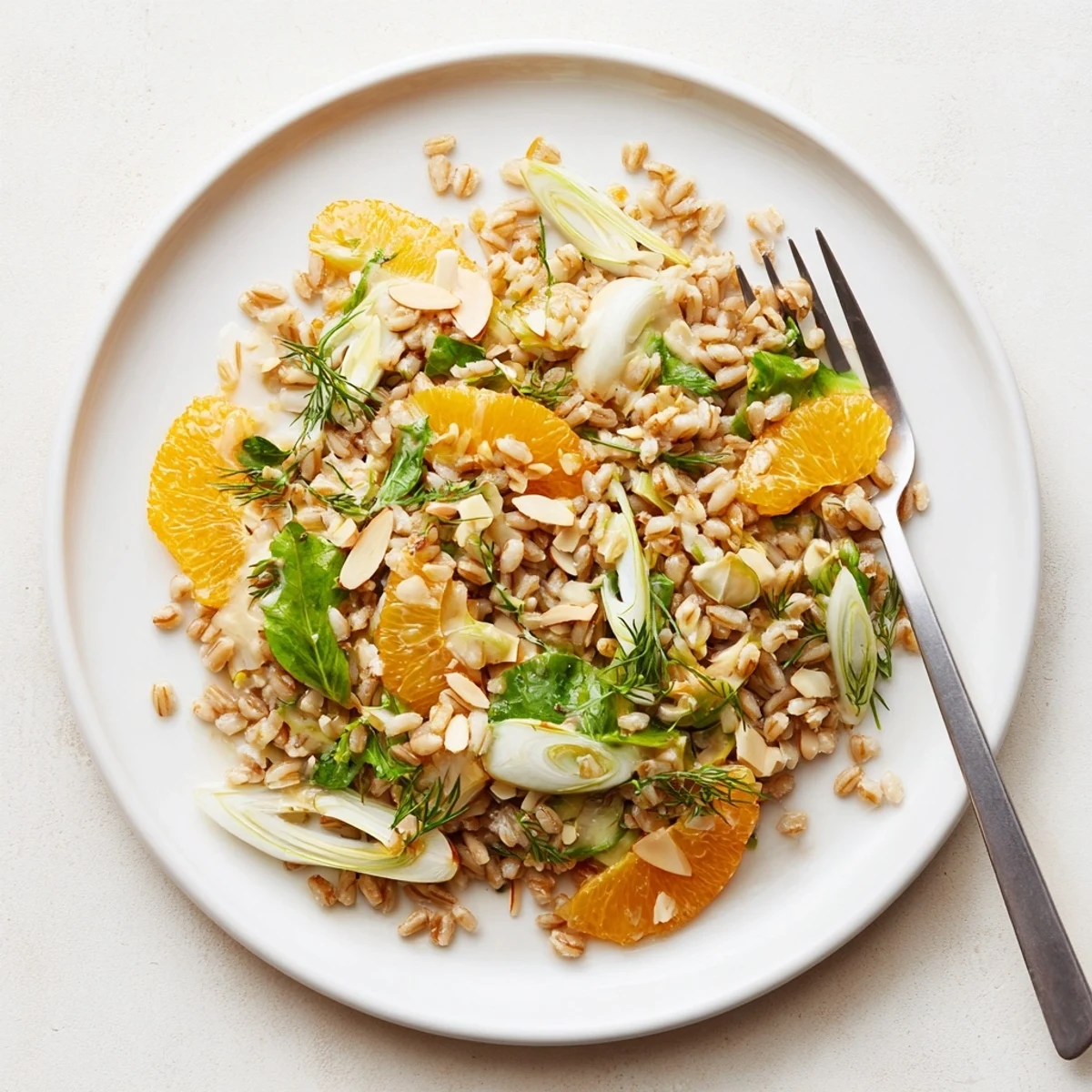 Farro salad with fennel, oranges, and almonds, tossed in citrus vinaigrette and served chilled.