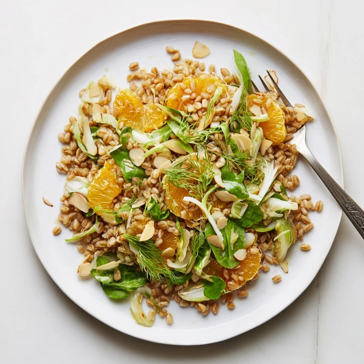 Toasted almonds and crisp fennel shine in this bright orange and green Mediterranean salad bowl.