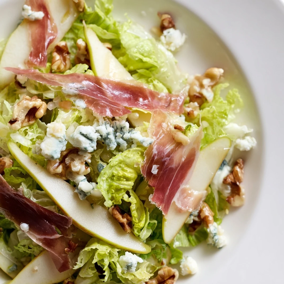 Crispy prosciutto and creamy blue cheese top a bed of frisée and ripe pears in this elegant salad.