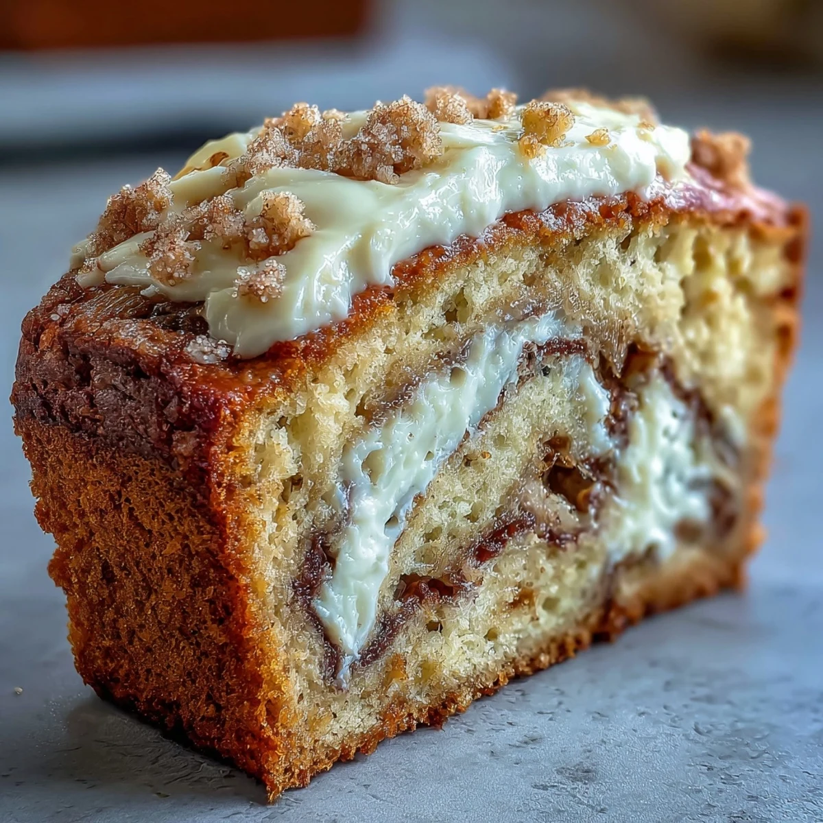 A close-up slice of Cream Cheese Cinnamon Swirl Banana Bread shows a moist crumb and rich, creamy filling.
