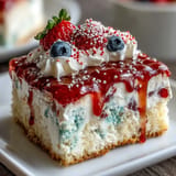 Vibrant Red White Blue Poke Cake dessert, swirled with sweet gelatin, perfect for parties.