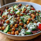 Fresh Mediterranean Chickpea Salad, packed with crisp cucumber, olives, and zesty dressing.