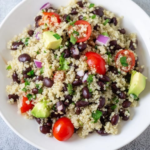 Vibrant Quinoa Black Bean Salad, a colorful mix of veggies and zesty lime dressing, ready to eat.