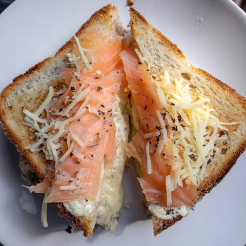 Perfectly browned Smoked Salmon Grilled Cheese oozing creamy cheese, a delicious pescatarian sandwich.