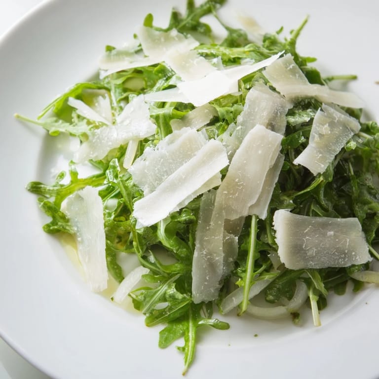 Beautifully plated arugula salad with lemon dressing, inviting flavors in this light Italian dish.