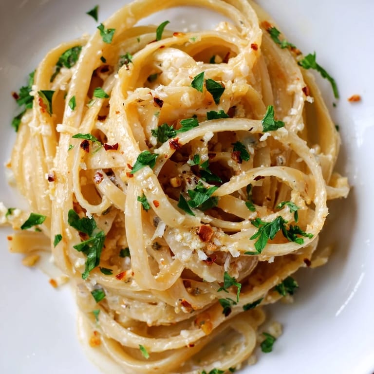 A quick Sriracha Honey Pasta with garlic butter, honey-sriracha glaze, and melted Parmesan cheese.